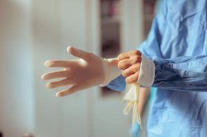 Stock Photo Doctor Putting On Surgical Gloves Before Medical Procedure Surgeon Getting Ready For The Surgery 2498890263 Transformed